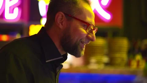 Hands deftly navigate pinball levers, transition to man's face, alight with Stock Footage 271297972