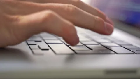 Hands delicately type out the lines needed to implement more effective Stock Footage 211937412