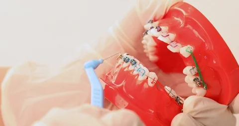 Hands demonstrating using an interdental brush, close up Stock Footage 97260676