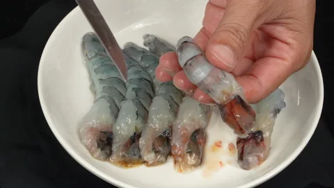 Hands Deveining And Butterflying Raw Black Tiger Shrimp Stock Footage 337053538