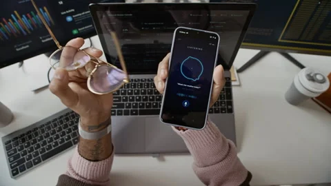 Hands of Developer Using Voice Assistant App on Smartphone at Workspace Stock Footage 337477881