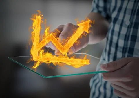 Hands with device with graph fire icon over. Blurred office background Stock Photos