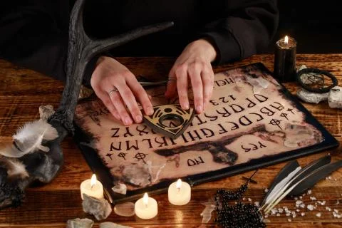 Hands on the devil's board. Session of calling spirits. Occult sciences, the  Stock Photos
