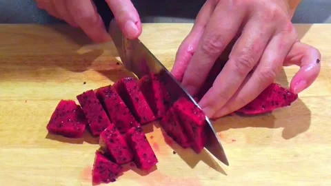 Hands Dicing Fresh Dragon Fruit on Wooden Board Stock Footage 345102384
