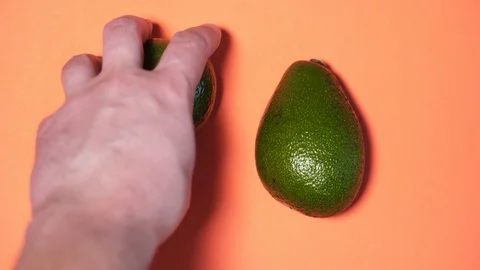 Hands of different people take away beautiful green avocados from a peach Video stock 126602393