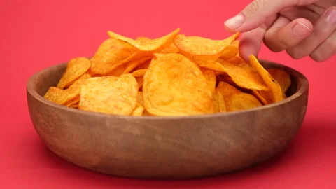 Hands of different people that take potatoes chips from wooden bowl Stock Footage 202879777