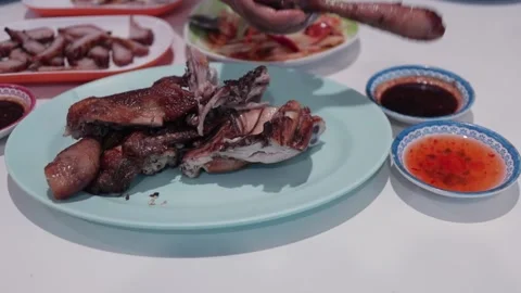 Hands Dipping Thai BBQ Grilled Chicken In Chili Sauce, Gai Yang Isaan Style Food Stock Footage 237587622