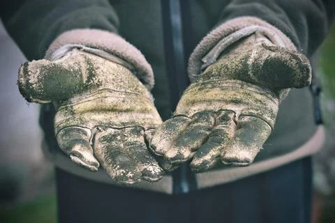 Hands with dirty working gloves Stock Photos