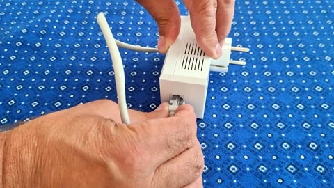 Hands Disconnect Cable to Powerline Ethernet Adapter Stock Footage 341840590
