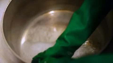 Hands of a dish washer scrubbing a large pan. Stock Footage 88405396