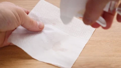Hands disinfect the table surface with alcohol and a napkin. Antibacterial tr Stock Footage 131364612