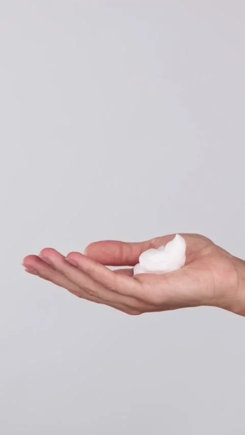 Hands Dispensing Cleansing Foam from Bottle Stock Footage 319134409
