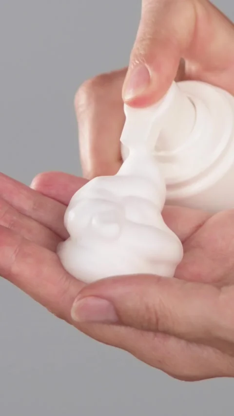 Hands Dispensing Cleansing Foam from Bottle Stock Footage 319135279