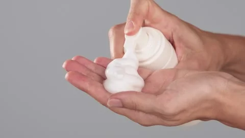 Hands Dispensing Cleansing Foam from Bottle Stock Footage 319169277