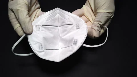 Hands with disposable gloves showing a model FFP2 protective device Stock Footage 141717003