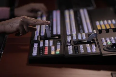 Hands on dissolve of Switcher buttons in studio TV station, Stock Photos