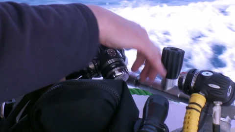Hands of diver prepare diving aqualung for diving on yacht. Stock Footage 233492940
