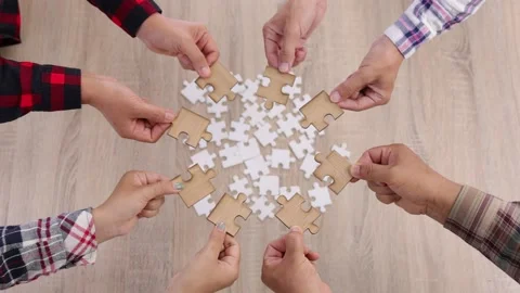 Hands of diverse people assembling jigsaw puzzle, Youth team put pieces toget Stock Footage 197345764