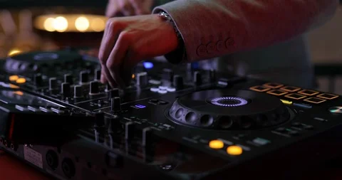 Hands of DJ mixing tracks on console panel in a nightclub, closeup Video stock 98131448