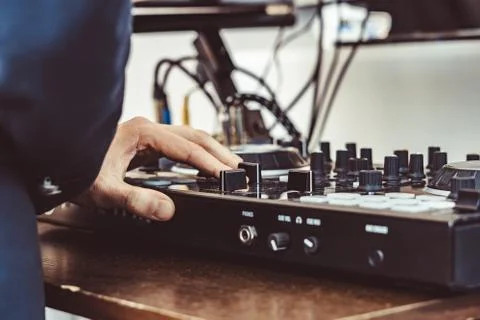 The hands of the DJ on the remote control Stock Photos