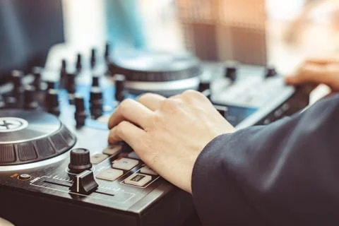The hands of the DJ on the remote control Stock Photos