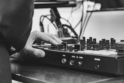 The hands of the DJ on the remote control Stock Photos