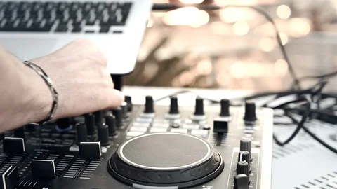 Hands Of Dj Tweak Controls  djing on the beach bar at sunset Stock Footage 111789111