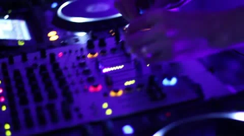 Hands of DJ tweak controls on record deck in night club. Turntable, mixer, plate Video stock 20620204