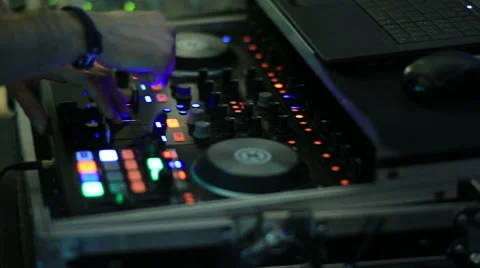 Hands of DJ tweak various track controls on dj's deck Stock Footage 63544636