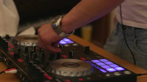 Hands of DJ tweak various track controls on dj's deck, camera is breathing Stock Footage 67107654