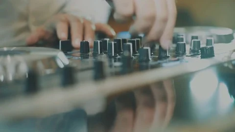 Hands of DJ tweak various track controls on dj's deck, 스톡 동영상 70542855