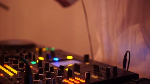 Hands of DJ tweak various track controls on dj's deck, camera is breathing Stock Footage 78567391