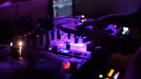 Hands of DJ tweak various track controls on dj's deck Stock Footage 80369411