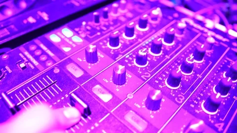 Hands of DJ tweak various track controls on dj's deck Stock Footage 86895151