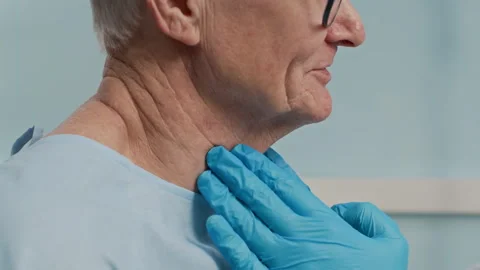Hands of Doctor Examining Tonsils of Senior Patient in Clinic Stock Footage 303876535