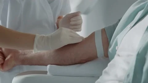 Hands doctor preparing taking blood from the patient in light room. Blood Stock Footage 202998658
