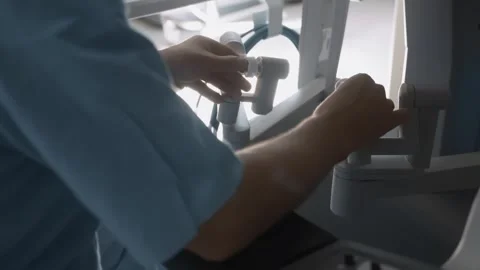 Hands of doctor using advanced robotic surgical system in operating room Stock Footage 241822274