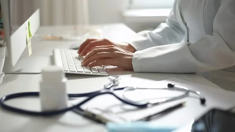 Hands of a doctor working on a computer keyboard. Close-up. Stock Footage 117518111