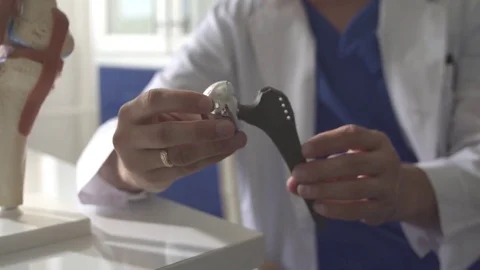 In the hands of doctors implant the hip joint Stock Footage 77418100