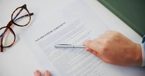 Hands, document and non disclosure agreement at office with reading, review and Stockfoto's