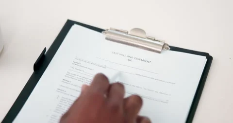 Hands, document and reading testament in home for last will, asset distribution Stock Footage 332968133