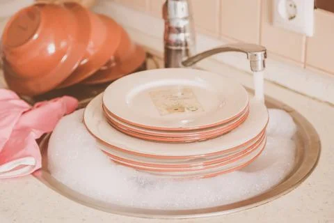 Hands doing the dishes in the sink Stock Photos