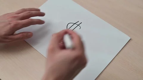 Hands draw a dollar sign on paper with a marker, followed by an upward arrow 库存影片 337550505