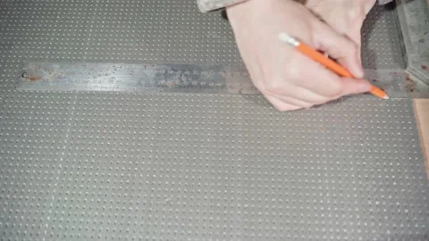 Hands draw a line with a pencil under the ruler on gray dense foam Stock Footage 168786254