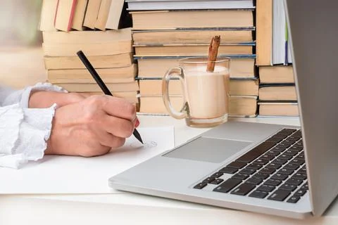 Hands draw near the computer and books Stock Photos