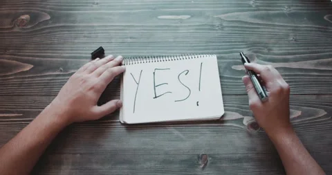 Hands drawing an YES on paper with marker Stock Footage 260938121