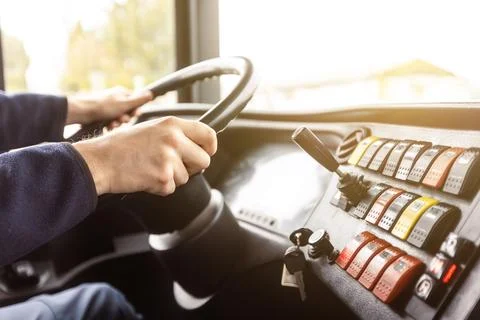 Hands of the driver in a modern bus according to the ride, detail of the bus Stock Photos