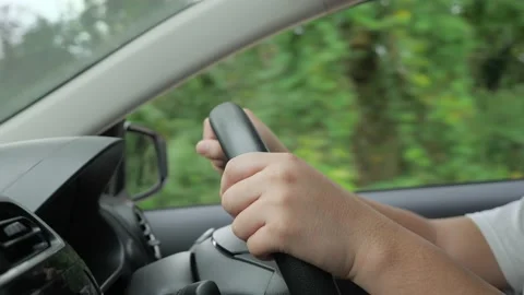 Hands of driver on steering wheel, driving a car concept, close up Stock Footage 150562259