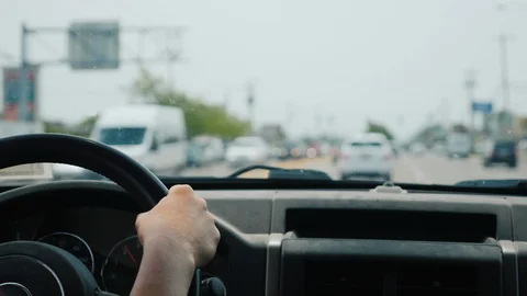 Hands of the driver on the steering wheel, riding in traffic jams Stock Footage 117665582