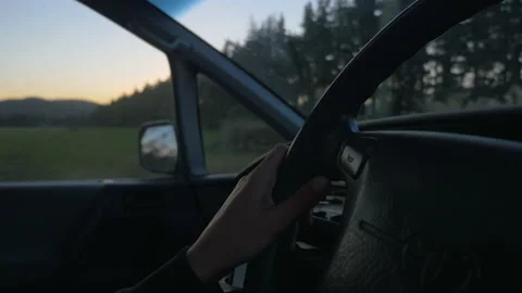 Hands driving a car at dusk, in New Zealand Stock Footage 219241133